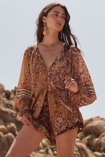 The Melody Blouse in Woodstock is crafted for the rebel hearts. Our newest blouse features a unique patchwork print placement from the design team ~ our honeyed amber print to one side, our rambling florals in pink and cream to the other with our retro brown and ditsy floral print across the back yoke complete this statement style and echo the free spirit of our rebel muse. Inserted ladder lace frames the billowing sleeves, a button down front offers styling versatility while the neck line includes ties wit