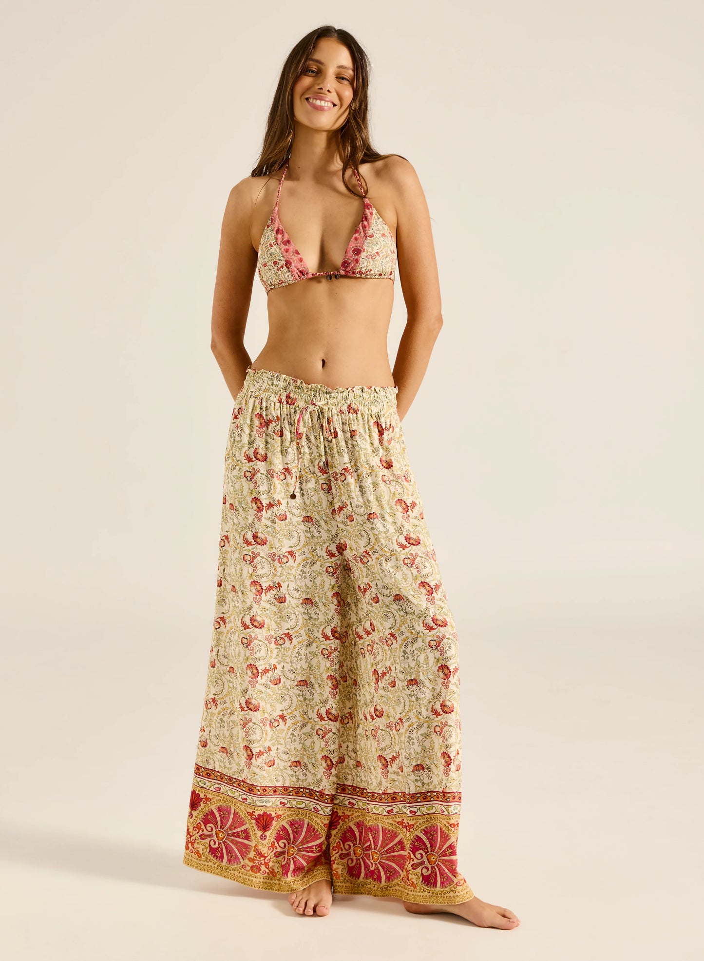 Step into style with the Valentina Pant, a wide-leg palazzo design featuring a charming ruffle edge and a drawstring finish. With convenient side slash pockets, these versatile pants can be worn as a statement style or as luxe over-swim.

Product Details:

Wide leg palazzo pant
Elastic waistband with ruffle edge
Drawstring finish
Side slash pockets
Wear as a pant or over swim
Full length