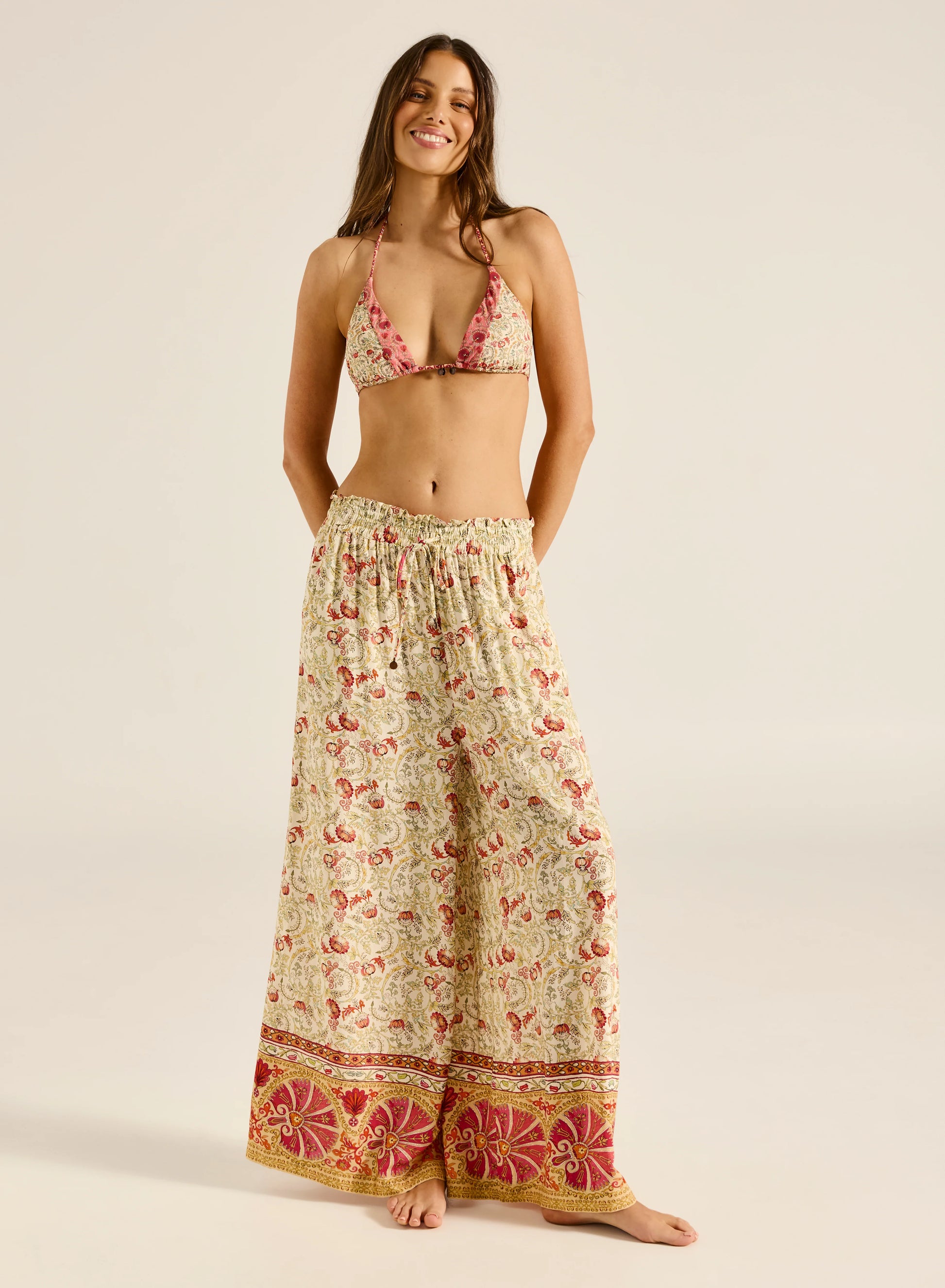 Step into style with the Valentina Pant, a wide-leg palazzo design featuring a charming ruffle edge and a drawstring finish. With convenient side slash pockets, these versatile pants can be worn as a statement style or as luxe over-swim.

Product Details:

Wide leg palazzo pant
Elastic waistband with ruffle edge
Drawstring finish
Side slash pockets
Wear as a pant or over swim
Full length