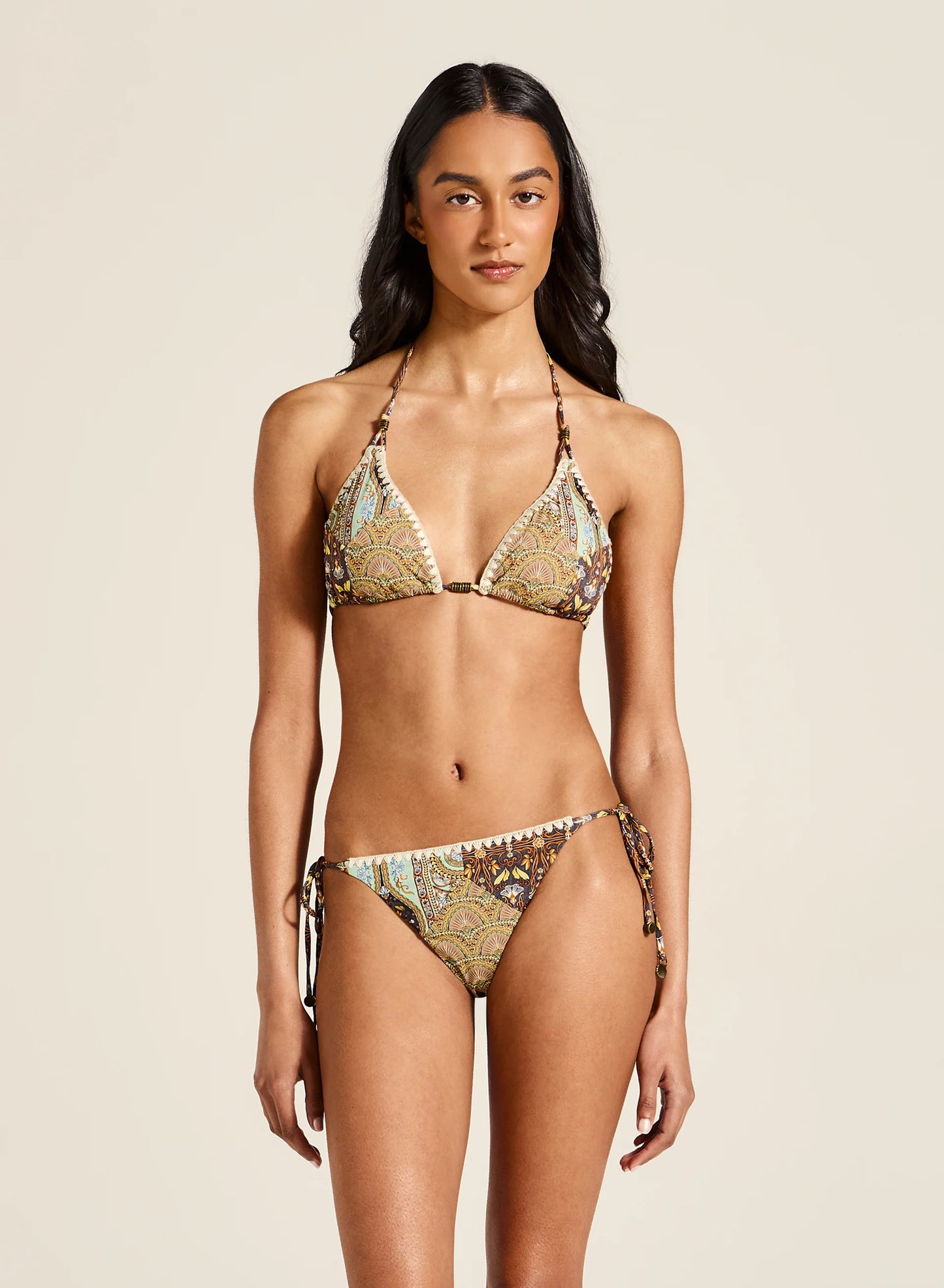 This timeless triangle shape is elevated with stunning custom patchwork details, infusing a unique feel into a beloved design. The feature blanket stitch and metal charms add a special touch, creating you the perfect statement swim style.