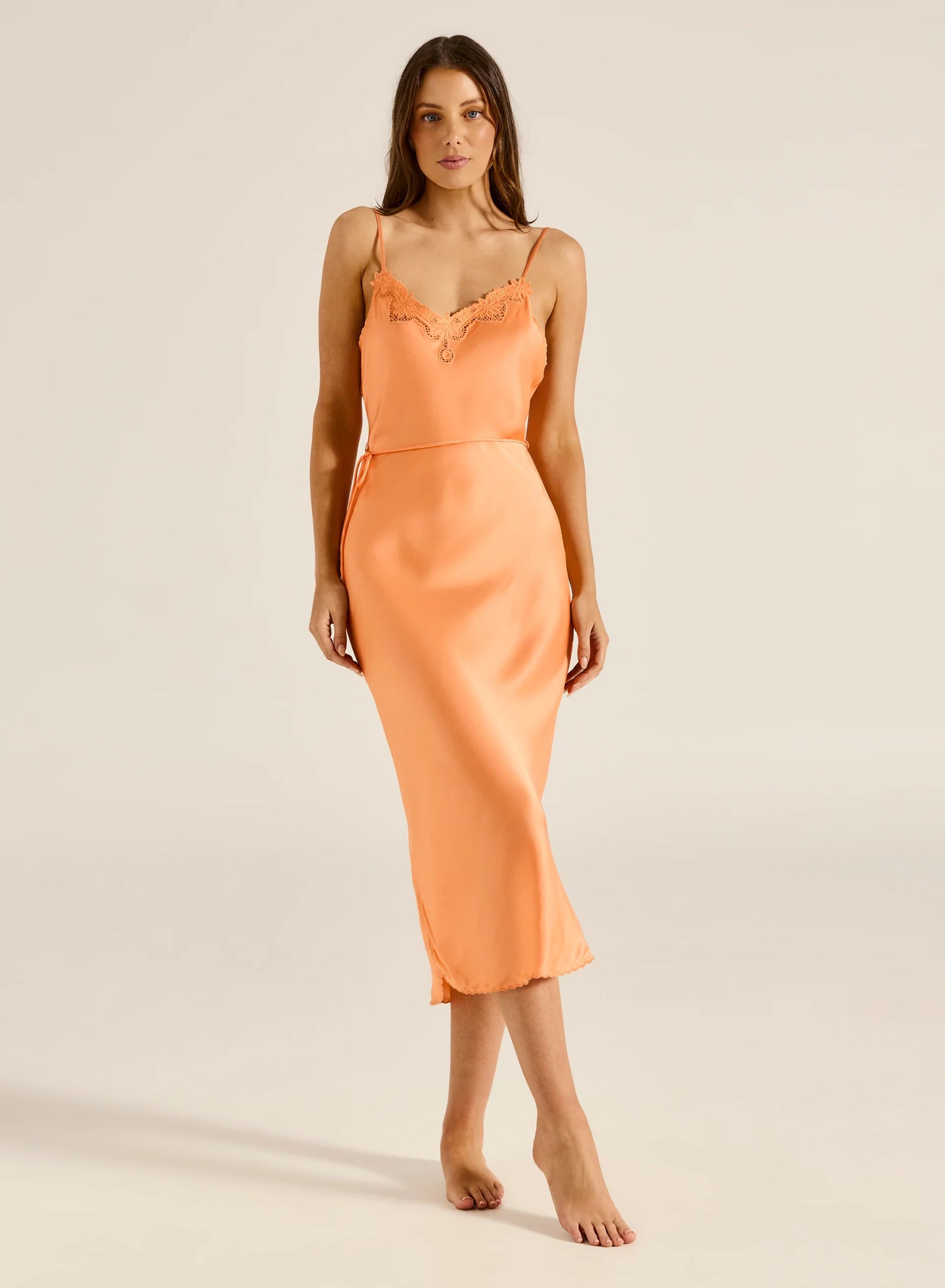 A breathtaking bias-cut midi slip dress featuring a flattering V neckline, a low back, and adjustable straps for the perfect fit. This exquisite piece is designed in the perfect midi length with a beautiful delicate drape.