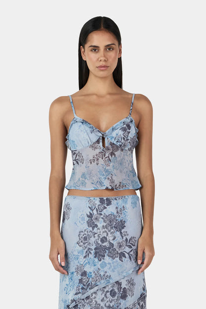 The Tiggy Camisole is a triangle cup cami top with gathers at the bust seam and a ruffled neckline. The Camisole has adjustable straps and a centre front keyhole. Designed to elevate any look.