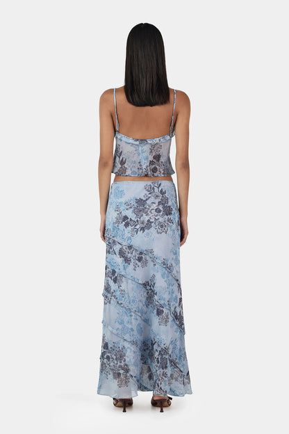 The Tiggy Camisole is a triangle cup cami top with gathers at the bust seam and a ruffled neckline. The Camisole has adjustable straps and a centre front keyhole. Designed to elevate any look.