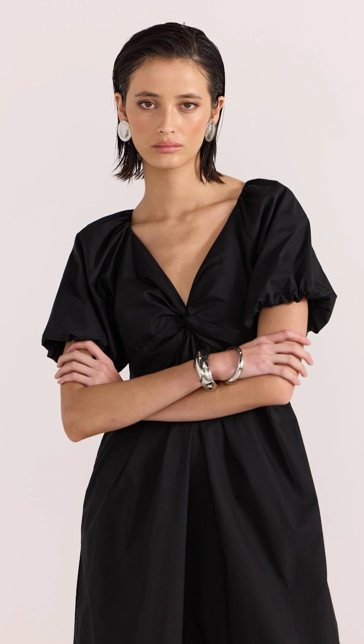 Update your LBD this season, with the new-in Ilana Twist Front Dress by Staple the Label. Featuring a knot design at the center front, short puffed sleeves, and a relaxed skirt shape. Pair with a barely there heel to complete the day to night look.