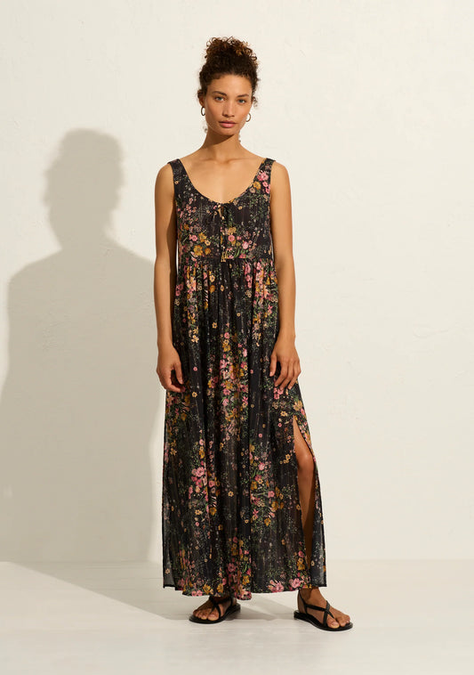 The bestselling Beachside Maxi Dress in our striking black Whisper Floral print is an all-time bestseller for a reason, and everybody's favorite silhouette. Crafted from soft cotton with our signature gold lurex threads, it includes a round neckline, button-front closure with specialty bead ends, and side seam splits, making it your perfect summer essential.