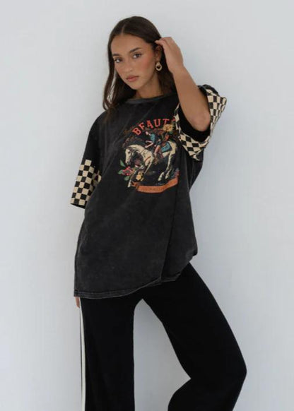 Black Beauty Tee
Make a bold statement with the Black Beauty Tee — featuring a vintage-inspired graphic print and edgy checkerboard sleeve details. This oversized, washed black tee blends comfort and street-style effortlessly, perfect for laid-back days or dressing up with your favorite accessories.
