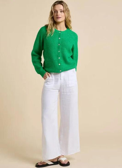 Add a pop of colour to your wardrobe with the Olivia Cardigan by Little Lies. Crafted in a vibrant fresh green hue, this timeless knit is designed with a slightly oversized fit for effortless layering and all-day comfort. Featuring a button-front closure with delicate shell buttons, it brings a touch of natural elegance to a classic silhouette.