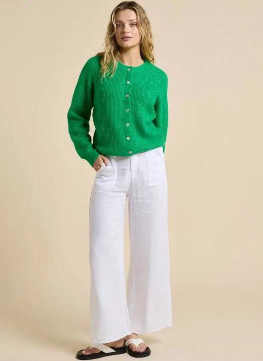 Add a pop of colour to your wardrobe with the Olivia Cardigan by Little Lies. Crafted in a vibrant fresh green hue, this timeless knit is designed with a slightly oversized fit for effortless layering and all-day comfort. Featuring a button-front closure with delicate shell buttons, it brings a touch of natural elegance to a classic silhouette.