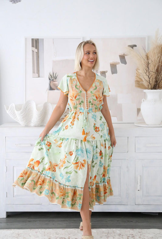Step into effortless elegance with the Isla Midi Dress, a floaty, feminine piece designed to brighten your wardrobe. With its soft pastel base adorned in vibrant orange, green, and aqua floral prints, Isla is the perfect blend of fresh, playful, and chic.