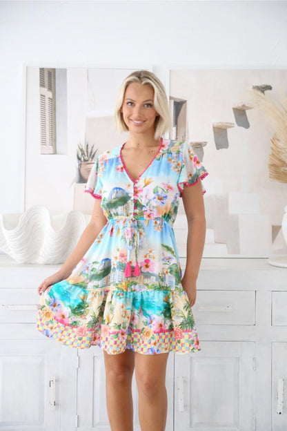 Bright, playful, and made for sunshine days — the Summer Mini Dress is the ultimate vacation-ready piece. Bursting with tropical charm, this dress features a lively coastal-inspired print with vibrant florals, ocean hues, and a fun checked border that instantly lifts your mood.