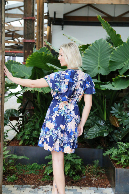 Playful, feminine, and effortlessly chic — the Bella Mini Boho Dress is your new go-to for carefree days and balmy nights. Designed with a flattering A-line silhouette, this mini features a vibrant floral print against a rich navy base, making it both eye-catching and versatile.