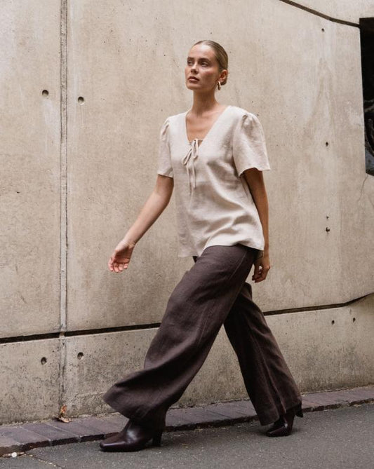 The Delight Top - Oatmeal

The White Closet Oatmeal Linen Top combines comfort and chic with its breathable linen fabric and floaty sleeves. Its loose fit allows for a relaxed style, while the elegant front tie-up across the bust adds a feminine touch. Wear it loose for effortless ease or tuck it in to highlight your silhouette. This versatile top is perfect for elevating your everyday look with understated sophistication.