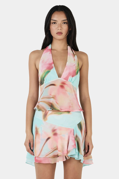 The Yiana Mini Skirt is a bias cut mini skirt with a layered, flowy design and an asymmetrical hem. The skirt is fully lined and pairs perfectly with the Lolita Top for a complete set.