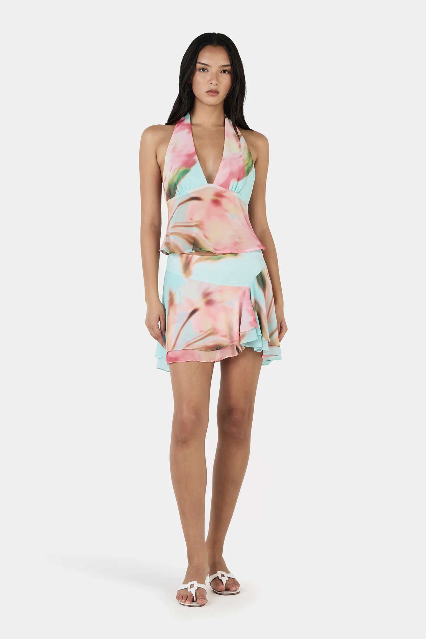 The Yiana Mini Skirt is a bias cut mini skirt with a layered, flowy design and an asymmetrical hem. The skirt is fully lined and pairs perfectly with the Lolita Top for a complete set.