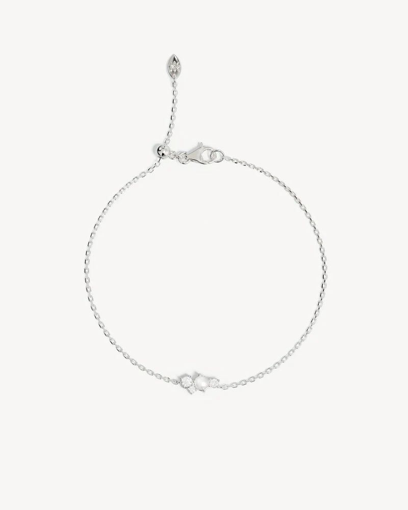 The Love in Stillness Pearl Bracelet celebrate those unseen moments - when we close our eyes to feel deeper, to connect beyond sight with love, with memory, with presence. This keepsake is an expression of romance in its softness and stillness.&nbsp;

18k Gold Vermeil: 2.5 microns of 18 carat gold coating a sterling silver base.&nbsp;

Delicate pearl cluster design.&nbsp;

Set with a round freshwater pearl and cubic zirconias in a claw setting.&nbsp;

Bracelet length: 19cm.&nbsp;

Features a silicon ball sl