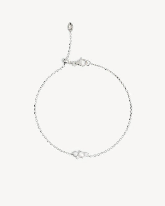 The Love in Stillness Pearl Bracelet celebrate those unseen moments - when we close our eyes to feel deeper, to connect beyond sight with love, with memory, with presence. This keepsake is an expression of romance in its softness and stillness.&nbsp;

18k Gold Vermeil: 2.5 microns of 18 carat gold coating a sterling silver base.&nbsp;

Delicate pearl cluster design.&nbsp;

Set with a round freshwater pearl and cubic zirconias in a claw setting.&nbsp;

Bracelet length: 19cm.&nbsp;

Features a silicon ball sl