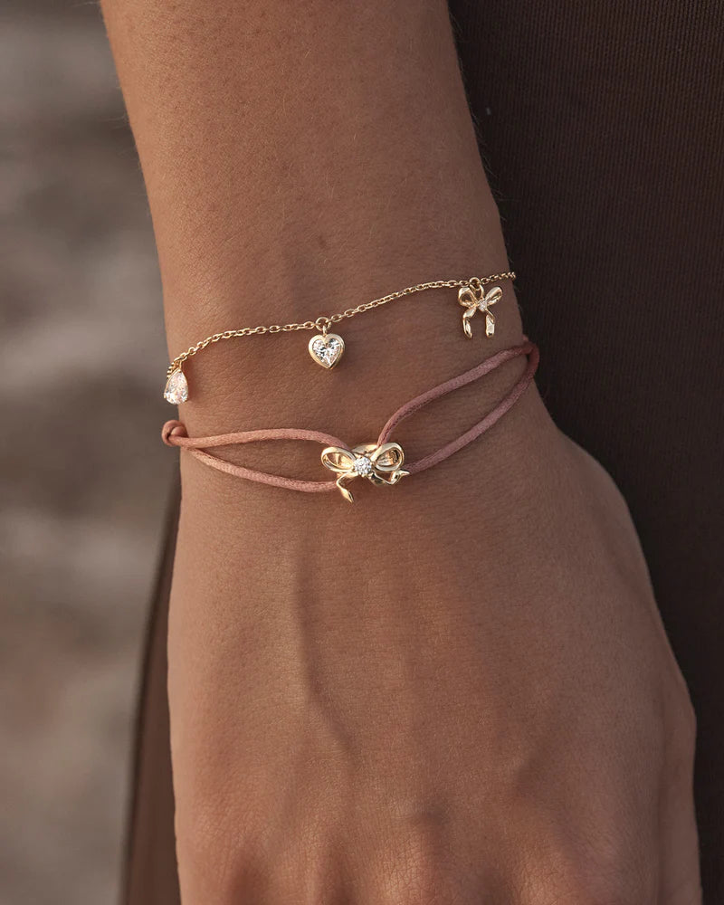 The Forever Yours Charm Bracelet is a reminder to embrace love in all its forms; its depth, stillness and radiance. This playful, feminine and delicate charm design is perfect for layering back with your favourite By Charlotte styles.&nbsp;

18k Gold Vermeil: 2.5 microns of 18 carat gold coating a sterling silver base.&nbsp;

Bracelet length: 19cm.&nbsp;

Features a silicon ball slider to customise length.&nbsp;

Heart pendant: 5mm.&nbsp;

Pear crystal pendant: 5 x 3mm.&nbsp;

Crystal Heart pendant: 5mm.&nb