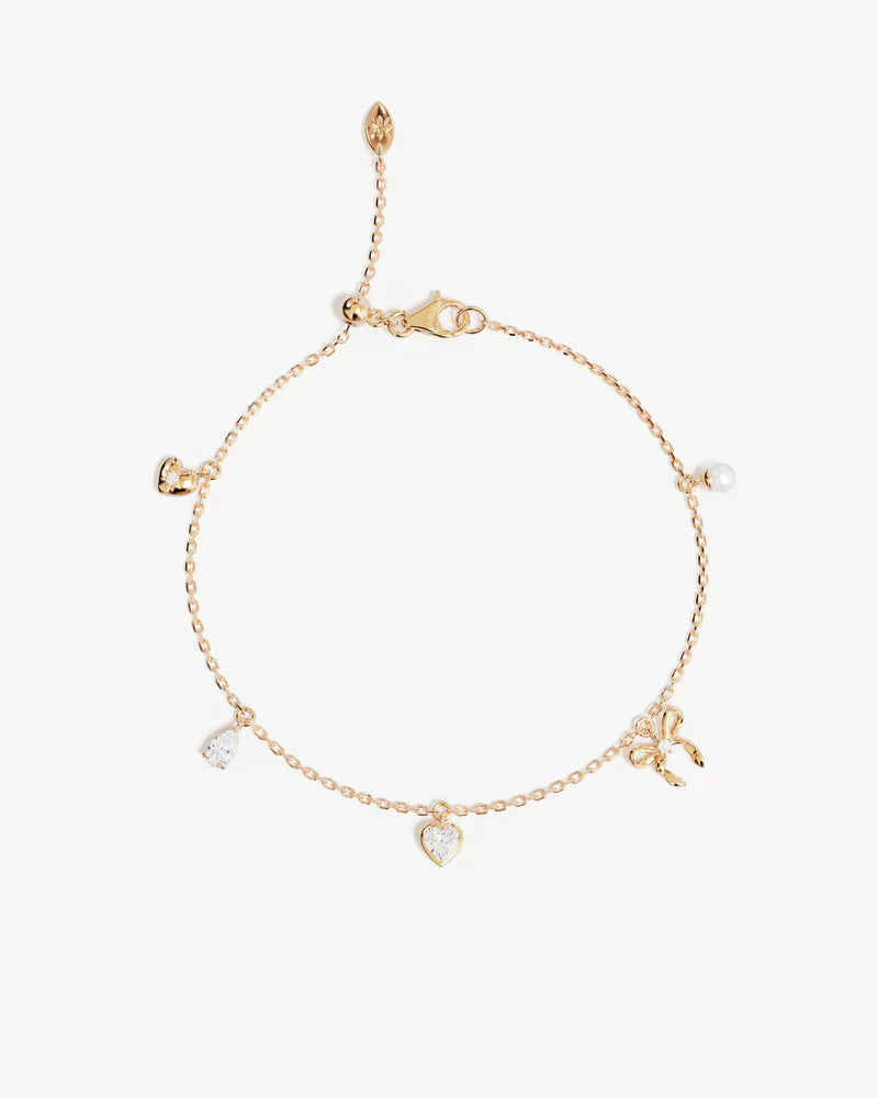 The Forever Yours Charm Bracelet is a reminder to embrace love in all its forms; its depth, stillness and radiance. This playful, feminine and delicate charm design is perfect for layering back with your favourite By Charlotte styles.&nbsp;

18k Gold Vermeil: 2.5 microns of 18 carat gold coating a sterling silver base.&nbsp;

Bracelet length: 19cm.&nbsp;

Features a silicon ball slider to customise length.&nbsp;

Heart pendant: 5mm.&nbsp;

Pear crystal pendant: 5 x 3mm.&nbsp;

Crystal Heart pendant: 5mm.&nb