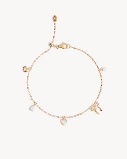 The Forever Yours Charm Bracelet is a reminder to embrace love in all its forms; its depth, stillness and radiance. This playful, feminine and delicate charm design is perfect for layering back with your favourite By Charlotte styles.&nbsp;

18k Gold Vermeil: 2.5 microns of 18 carat gold coating a sterling silver base.&nbsp;

Bracelet length: 19cm.&nbsp;

Features a silicon ball slider to customise length.&nbsp;

Heart pendant: 5mm.&nbsp;

Pear crystal pendant: 5 x 3mm.&nbsp;

Crystal Heart pendant: 5mm.&nb