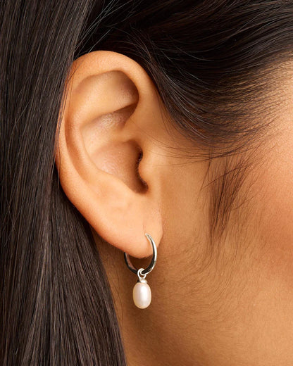 Find inner peace, balance and tranquillity with our&nbsp;Silver&nbsp;Live in Peace Hoops. This elevated take on the classic pearl earring is designed to inspire optimism and stillness, even amidst chaos.