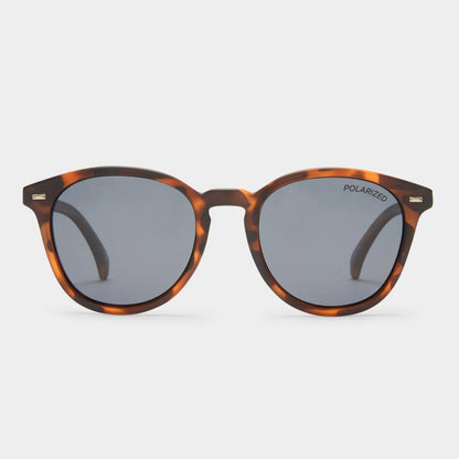 With vintage inspired details, our iconic BANDWAGON frame is the perfect all-round sunglass offering a timeless aesthetic. Featuring a keyhole nose bridge and refined angles, this midsize style is finished with discreet metal rivet detailing and Le Specs flagstripe metal hardware.

• Finished in a matte tort frame paired with dark smoke mono lenses.
• A lightweight, durable and impact resistant polycarbonate frame.
• Fitted with polarized lenses to eliminate unwanted reflective glare.