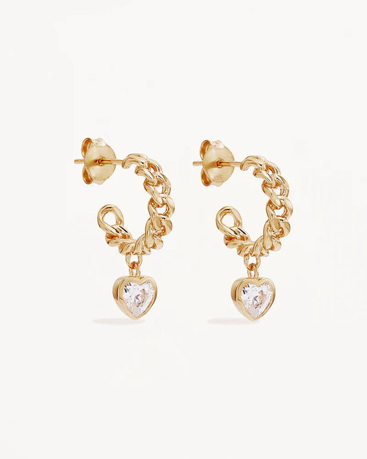The&nbsp;Radiant Heart&nbsp;Curb Hoops&nbsp;showcase&nbsp;a&nbsp;sparkling heart-shaped stone, symbolising love as genuine and unconditional. Let your love&nbsp;radiate from the inside out - unfiltered and authentic.&nbsp;Available in 18k gold vermeil.&nbsp;

2.5 microns of 18&nbsp;carat gold&nbsp;coating a&nbsp;sterling&nbsp;silver&nbsp;base.&nbsp;
Sold as a pair.
Hoop width: 4mm.
Hoop inner diameter: 10mm.
Set with 5mm heart&nbsp;cut&nbsp;cubic&nbsp;zirconia&nbsp;crystals&nbsp;in a bezel setting.
Polished