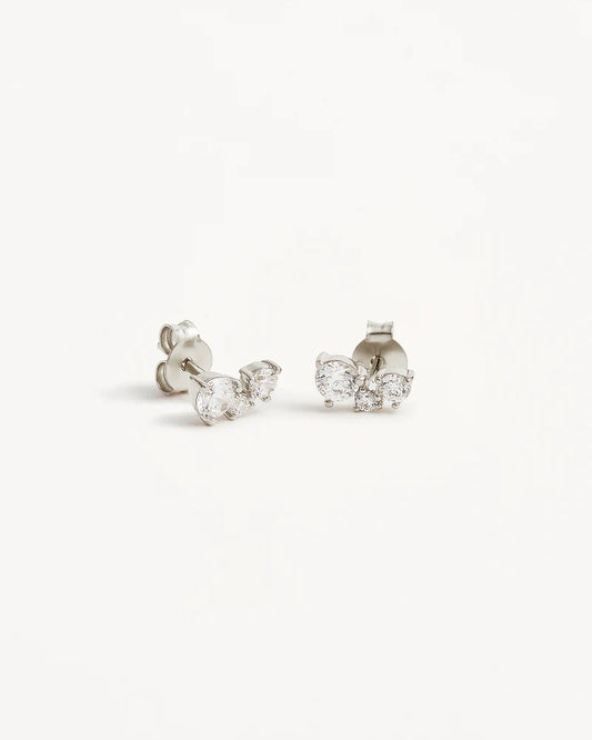 The&nbsp;Whispers of Love&nbsp;Stud Earrings&nbsp;feature&nbsp;a classic trio design with an asymmetrical twist with varying sizes of round-cut crystals. This piece is a visual poem to the simplicity of love - and all the quiet magic it holds.&nbsp;It’s&nbsp;classic and delicate design is the perfect subtle touch of sparkle for the bride looking to shine in her own light.&nbsp;