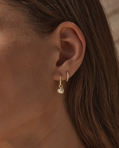 By Charlotte - The You Have My Heart Hoops is a joyful and sparkling proclamation of love and connection, re-imagining the heart motif into a playful charm design featuring alternating crystal encrusted pendants. Wear this design as a reminder of the love that surrounds, enriches, and strengthens you every day.&nbsp;

18k Gold Vermeil: 2.5 microns of 18 carat gold coating a sterling silver base.&nbsp;

Pendants are removable.&nbsp;

Set with cubic zirconias in claw and pavé settings.&nbsp;

Sold as a pair.&