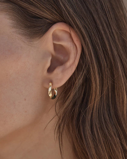 By Charlotte -&nbsp;The Return to Love Hoops are inspired by the graceful, twisting movement of the bow. This keepsake is perfect for styling back with your everyday stack.&nbsp;

18k Gold Vermeil: 2.5 microns of 18 carat gold coating a sterling silver base.&nbsp;

Sold as a pair.&nbsp;

Hoop width: 2.5mm (varies).&nbsp;

Total length: 17mm approx.&nbsp;

Polished finish.&nbsp;