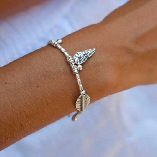 Crafted with solid Hill Tribe Silver beads and pendants, the Ocean Feathers Bracelet is built to last. Strung on durable polywax cotton and secured with a sterling silver parrot clasp, this bracelet combines strength with timeless ocean-inspired style. We love the many handmade charms this bracelet features, including our signature ocean bubble bead.