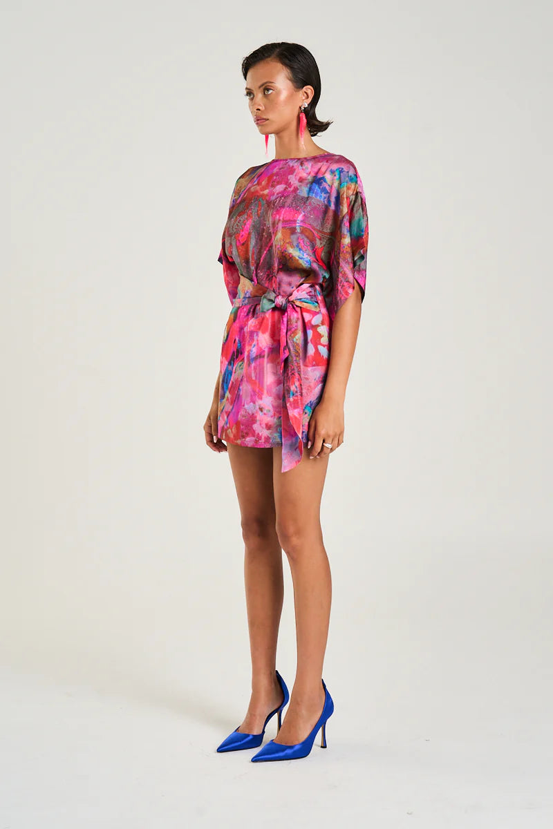 The Tie Front Dress featuring the Fish Tank print offers a versatile, figure-flattering design boasting a high neckline, modest sleeves, and a modern mini silhouette. Its wrap overlay ties at the side, allowing you to customise the length and fit to suit your style. Crafted from a durable linen and rayon blend, this dress combines comfort with a refined finish, making it ideal for both casual and polished looks.