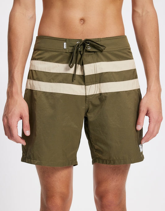 Inspired by vintage surf culture and built for modern adventure, the Market Trunks deliver effortless coastal style with everyday versatility. Crafted from recycled nylon for a lightweight yet durable feel, these trunks are designed to move with you — from the ocean to the street.

Featuring a contrast stripe design and a classic fixed waistband with a secure drawcord closure, they offer a timeless look with a tailored fit. Quick-drying and functional, they’re perfect for surf sessions, beach hangs, or week