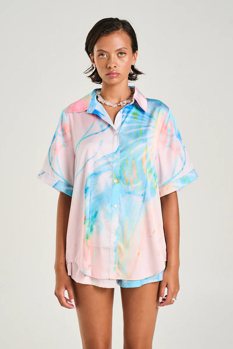 The Button Up Shirt made from silky cupro features the Medusa Phase print in soft pastel hues, designed for a sleek yet relaxed fit.

