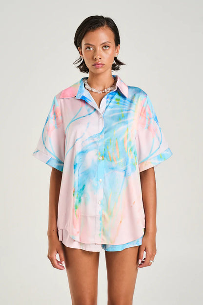 The Button Up Shirt made from silky cupro features the Medusa Phase print in soft pastel hues, designed for a sleek yet relaxed fit.

