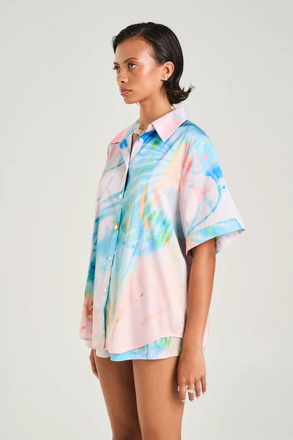 The Button Up Shirt made from silky cupro features the Medusa Phase print in soft pastel hues, designed for a sleek yet relaxed fit.

