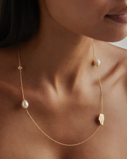 Our&nbsp;18k Gold Vermeil Moonlit Tides Necklace&nbsp;honours the relationship between the divine moon and the ocean.&nbsp;Set with a sparkling&nbsp;crystal&nbsp;and baroque freshwater pearls, this necklace can be worn wrapped around twice for a double layered necklace look.&nbsp;Just as the&nbsp;moon rules the tides of the sea,&nbsp;feel inspired to embrace&nbsp;your&nbsp;divine power.&nbsp;&nbsp;