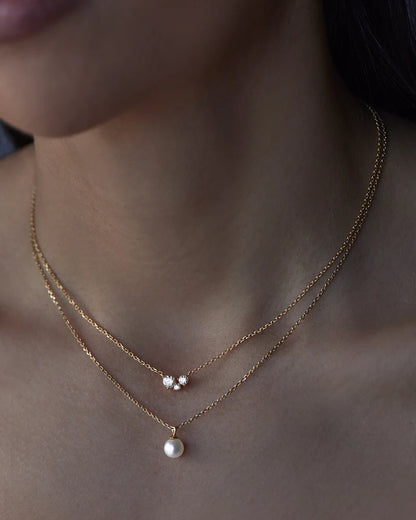 The&nbsp;Whispers of Love Necklace&nbsp;features a classic trio design with an asymmetrical twist&nbsp;with&nbsp;varying sizes of round-cut crystals.&nbsp;This piece is a&nbsp;visual poem to the simplicity of love - and all the quiet magic it holds.&nbsp;It’s&nbsp;classic and delicate design&nbsp;is the perfect subtle touch of sparkle for the&nbsp;bride&nbsp;looking to shine in her own light.&nbsp;