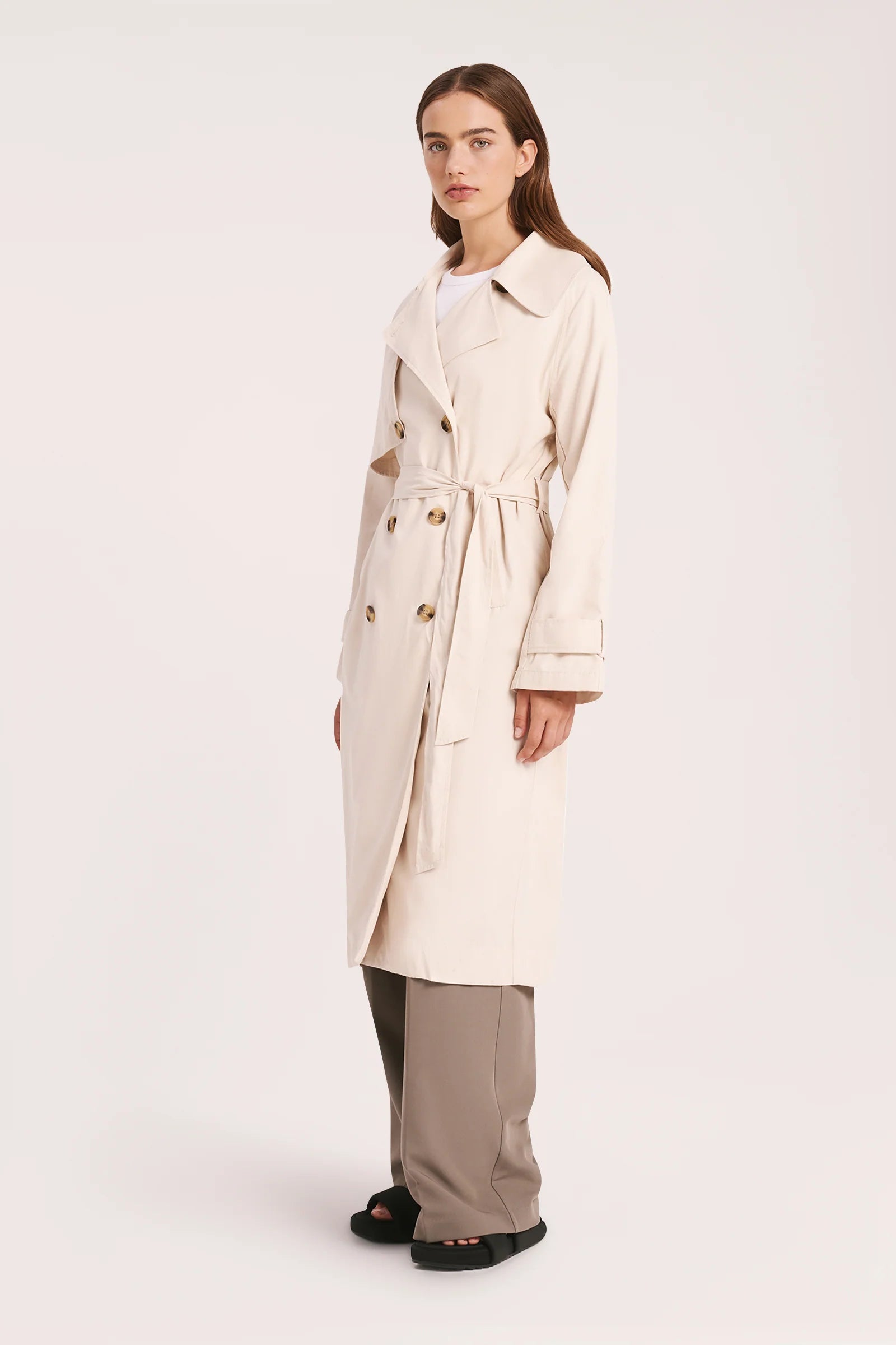 The Odyssey Trench coat is made from a sturdy cotton nylon blend with a peached/sueded finish. Fit is relaxed with wide full length sleeves &amp; body length finishing at knee level. Features include traditional trench coat detailing, double breasted button opening, waist tie &amp; storm flap.&nbsp;