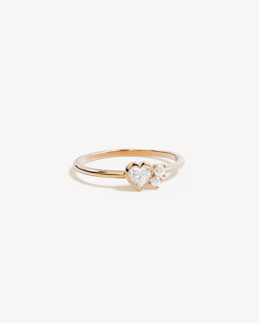 By Charlotte - The Dream Lover Heart Ring speaks to the unspoken connections and the in-between moments of utmost intimacy. The delicate heart cluster design encapsulates the dreamy moments of tender love and connections we hold closest to our hearts.&nbsp;

18k Gold Vermeil: 2.5 microns of 18 carat gold coating a sterling silver base.&nbsp;

Features heart (bezel setting) and round (claw) cut cubic zirconias.&nbsp;

Cluster design: 7 x 5mm.&nbsp;

Band height: 1.2mm.&nbsp;

Polished finish.&nbsp;