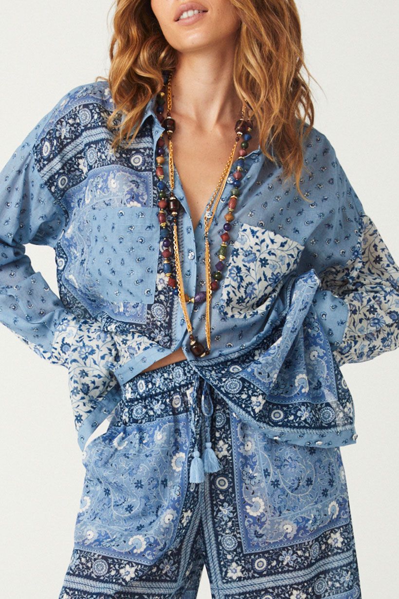 Step out with confidence in the latest SPELL statement Sunshine Bandit Shirt Dress in Chambray. This short dress marries western inspiration with modern intrigue, featuring patchwork floral, ditsy and border placement. Our shirt dress features front pockets, a flattering curved hem and a button down front that can be worn open as a cover up for styling versatility. 