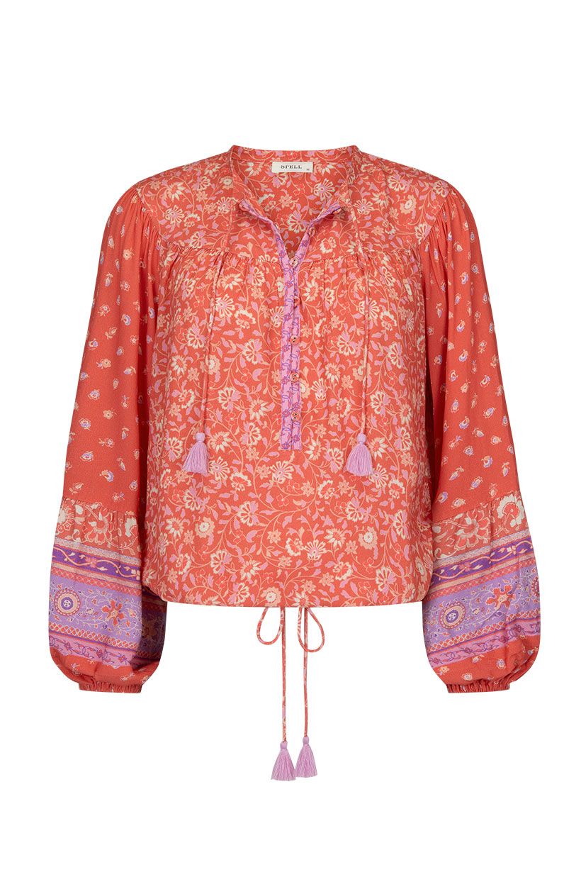 The SPELL Sunshine Bandit Blouse in Cayenne is crafted for the wild romantics. Our blouse is incredibly flattering, featuring a drawstring tie hem that can be left loose with the hem skimming the hips or pulled to the waist for a cropped option. Our blouse is elevated with neck ties and drawstring hem ties including handmade tassels, billowing sleeves and elegant gathers at the yoke. 