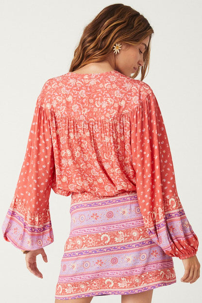 The SPELL Sunshine Bandit Blouse in Cayenne is crafted for the wild romantics. Our blouse is incredibly flattering, featuring a drawstring tie hem that can be left loose with the hem skimming the hips or pulled to the waist for a cropped option. Our blouse is elevated with neck ties and drawstring hem ties including handmade tassels, billowing sleeves and elegant gathers at the yoke. 