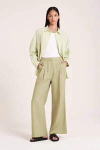 The Thilda Linen Pant is made 100% linen which has been washed for a soft, breathable hand feel. The silhouette is a classic mid-rise with wide tailored leg finishing full length. Features include front pleats at waist, elasticated back waistband &amp; concealed button and trouser hook closure.