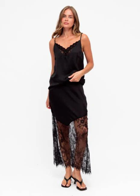 Unleash your bold side with our fierce Liberty Lace Trim Cami in black! This stunning top features a silky soft fabric, delicate lace trim, and adjustable straps. It's fully lined for ultimate comfort and style. Lace up your look today!