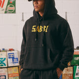 THE BE KIND HOODIE – ACID WASH BLACK

Stay bold, cozy, and kind in the Be Kind Hoodie in a warm terracotta hue. Made for comfort and attitude, this oversized hoodie features a standout yellow “SABBI” graphic across the chest, with dropped shoulders and a roomy front pocket for ultimate laid-back vibes. Crafted from premium cotton fleece, it delivers a soft, lived-in feel with a streetwear edge.