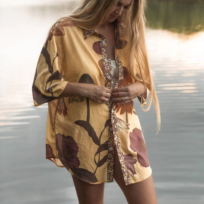 Our Glades Chamomile over swim Shirt is made from an organic cotton voile, a semi sheer fabric with all over large floral print featuring a contrast placket in the Petite Butter ditsy print, finished with coconut buttons up the front. It's a One size over swim shirt, that fits a size 6-8 to a size 16 with a different look on each size.