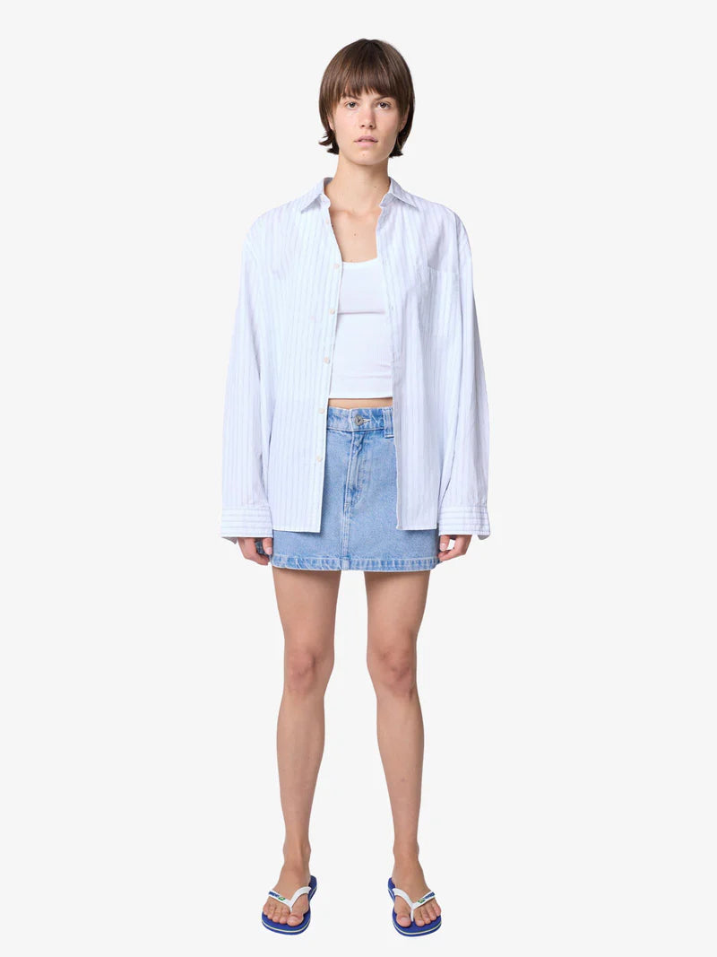 Channel effortless ’90s energy with the 95 A-Line Skirt - Jordan — your new denim essential designed for everyday cool.

Crafted from soft yet structured mid-wash blue denim, this mini skirt features a classic A-line silhouette that flatters every shape. With a mid-rise fit, raw hemline, and just the right amount of vintage edge, it’s the perfect balance of nostalgic and modern.