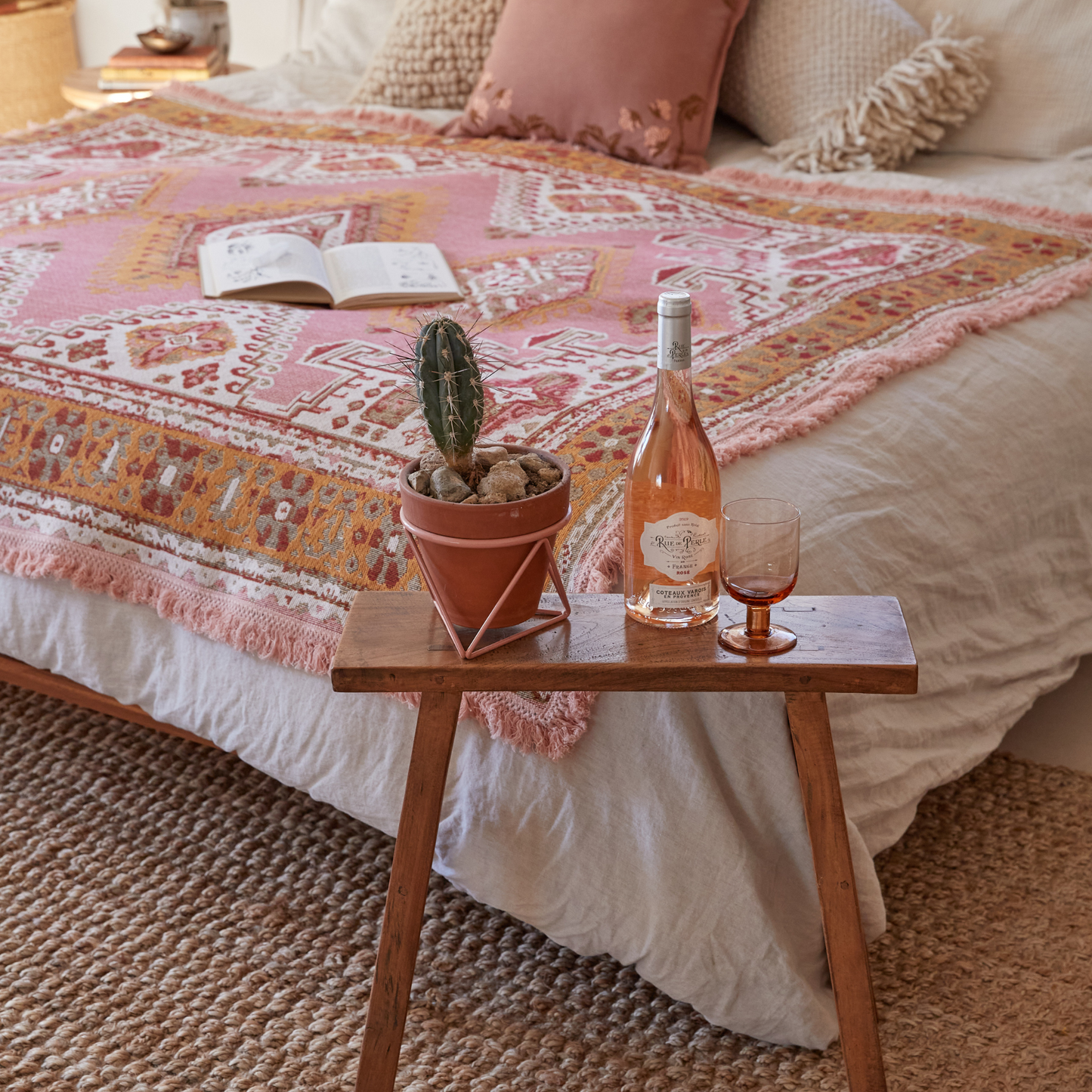 Wandering Folk Pink Sands Wandering Throw On top of Bed