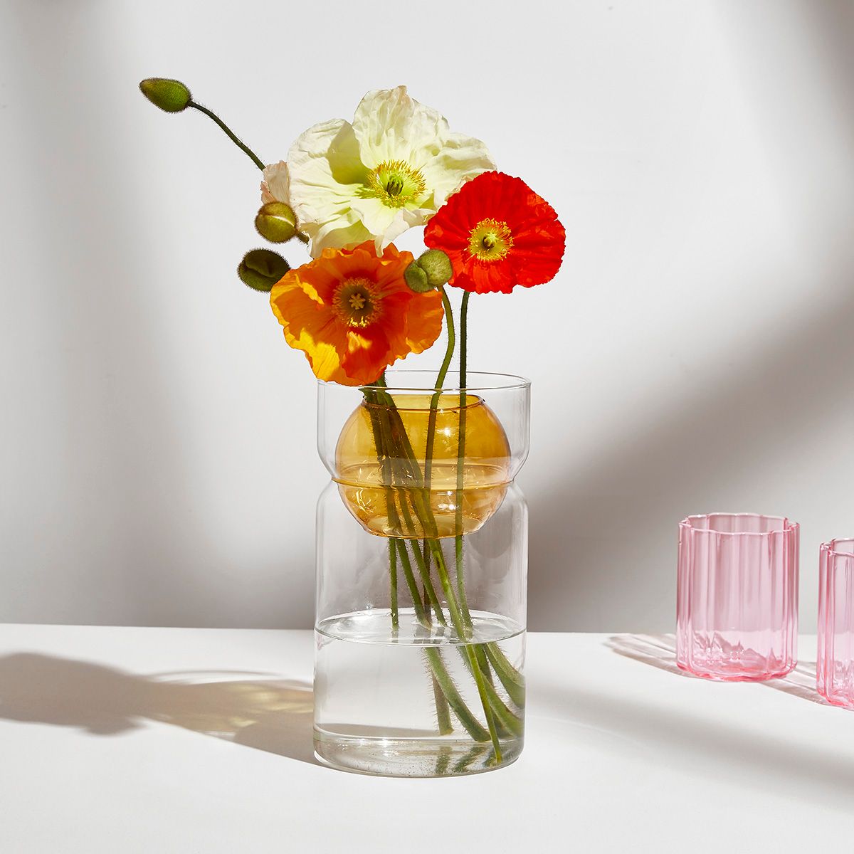 These playful cylindrical vases feature an internal sphere with two hand-cut holes ready to be filled with freshly picked flowers and foliage or to grace any space as a decorative sculptural piece.